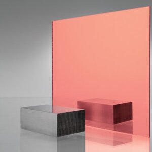 Coral/salmon pink tinted transparent acrylic sheet with metallic finish, showing soft peachy tone and colored reflection